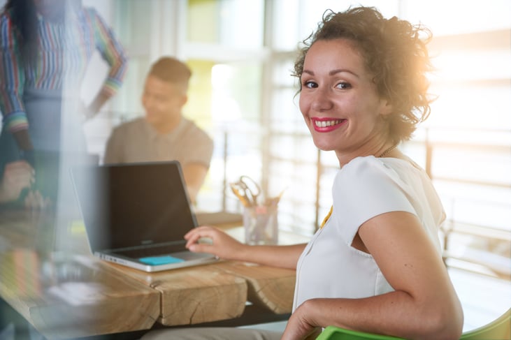 Image of a succesful casual business woman using laptop during meeting